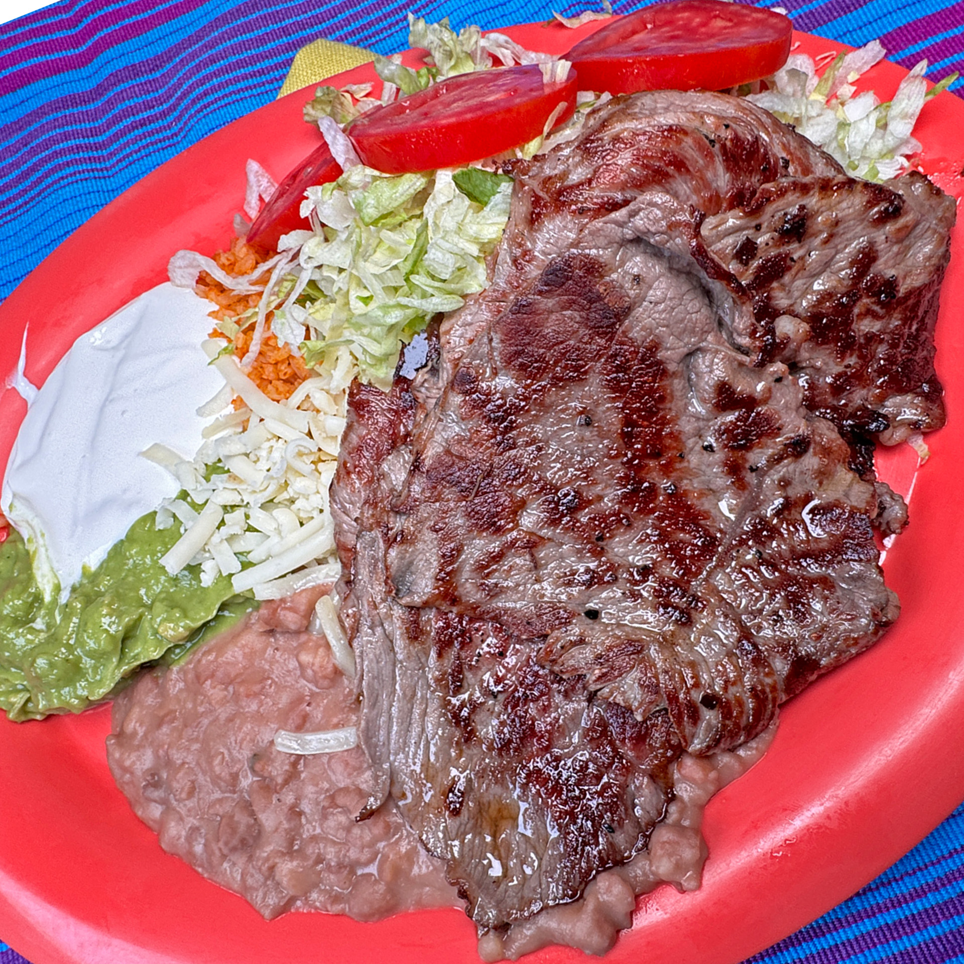 Juicy, perfectly grilled carne asada served with rice, beans, and warm tortillas.