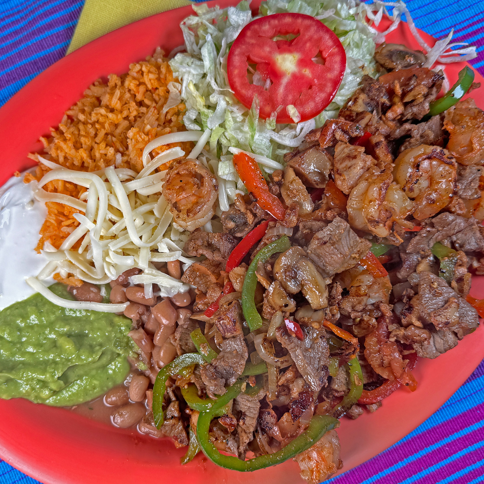 Sizzling mix of grilled steak, chicken, and shrimp with bell peppers and onions.